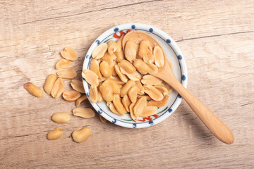 Peanuts in a cup on wooden background