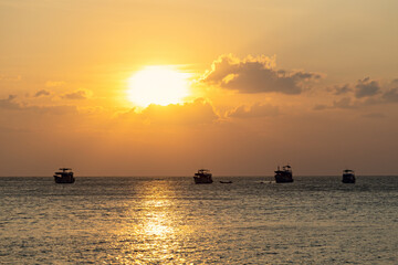 Fototapeta na wymiar Spectacular sunset with boats in the sea, Koh Tao, Thailand