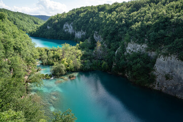 Fototapeta na wymiar Plitvice Lakes in Croatia. Sightseeing place. Very popular among tourists. Beautiful Landscape and Nature. Summer view of beautiful waterfalls in Plitvice Lakes National Park