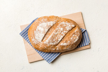 Freshly baked bread on cutting board against white wooden background. top view bread with copy space