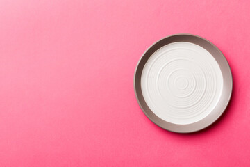 Top view of isolated of colored background empty round white plate for food. Empty dish with space for your design