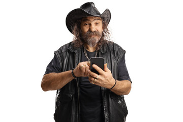 Bearded man with a leather cowboy hat using a smartphone