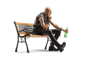 Pensive punk sitting on a bench with a bottle of beer