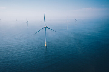 Wind turbine. Aerial view of wind turbines or windmills farm field in blue sea in Finland.