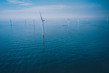 Wind turbine. Aerial view of wind turbines or windmills farm field in blue sea in Finland. - obrazy, fototapety, plakaty