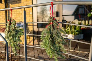 Christmas and New Year decoration outdoors, beautiful Christmas tree branches. Holiday festive atmosphere on a sunny day. 