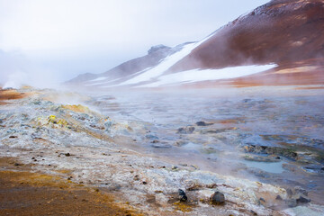 Boiling mudpots in the geothermal area Hverir and cracked ground around. Location: geothermal area Hverir, Myvatn region, North part of Iceland, Europe