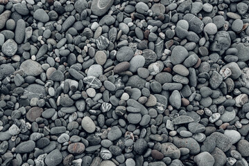 Abstract background with black and gray round sea pebble stones