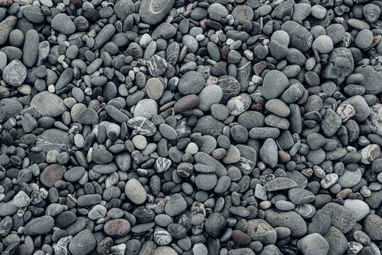 Abstract background with black and gray round sea pebble stones