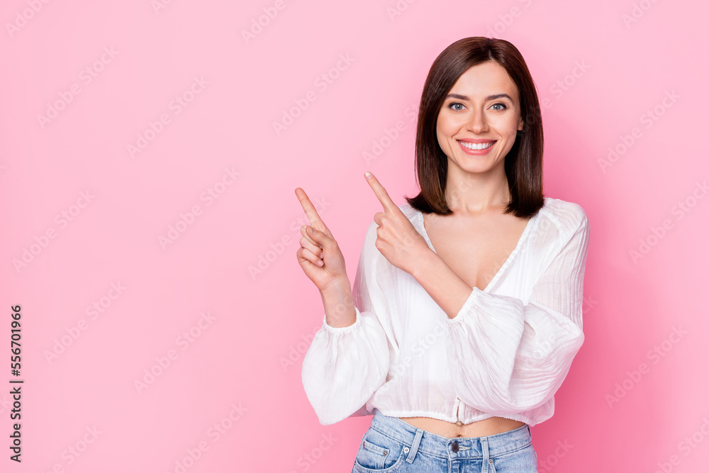 Sticker Photo portrait of winsome young girl toothy smile recommend look empty space dressed stylish white outfit isolated on pink color background