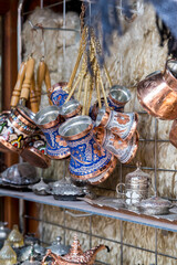 handmade and carved copper coffee pots. It is displayed on the market counter for sale. Selective focus Pots