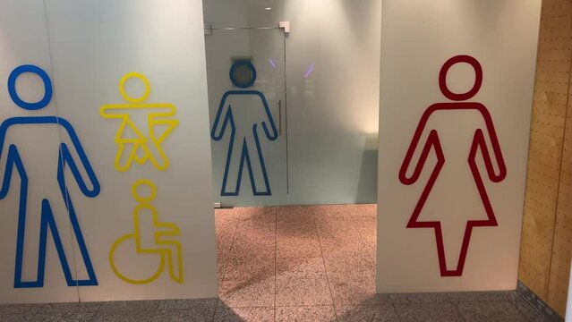 female and male toilet signs on frosted glass