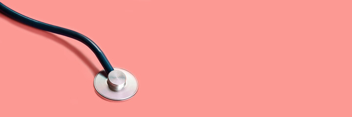 Phonendoscope for listening to the lungs and heartbeat on red background. Banner.