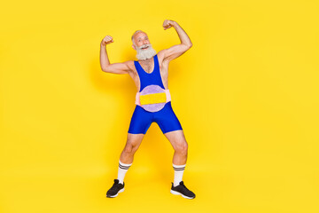 Fototapeta na wymiar Full body portrait of cheerful muscular grandfather wear champion belt flex biceps isolated on yellow color background