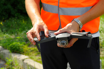 Operator hands adjusting drone for launching it