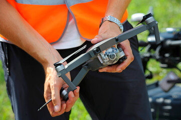 Operator hands adjusting drone for launching it