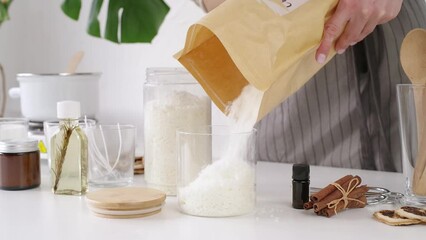 Creative occupation of candle making. woman making candles from soy wax, working in her creative space. pouring soy wax into glass jars