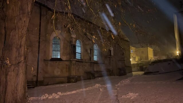 romanic church at christmas time with heavy snowfall