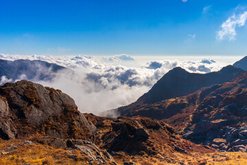 A view of heaven. Silver-white clouds filled in the valley surrounded by rocky brown mountains amid a clear blue sky are the best place to meditate.