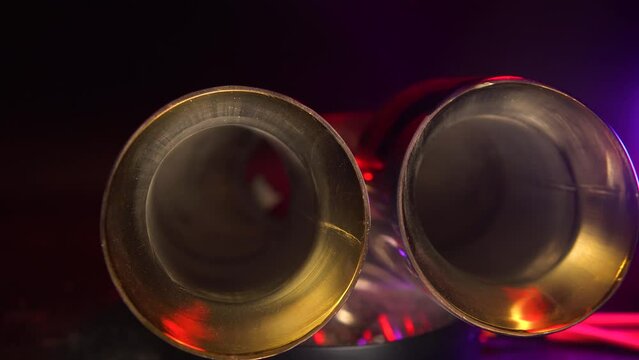 Chrome, double pipe of the vehicle's exhaust system. A good splitter for car tuning. Selective focus, dark background. Copy space