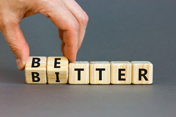 Better or bitter symbol. Concept word Better and Bitter on wooden cubes. Businessman hand. Beautiful grey table grey background. Business and better or bitter concept. Copy space. - obrazy, fototapety, plakaty