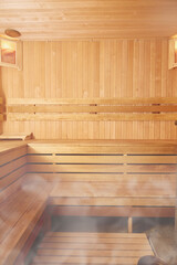 Fototapeta na wymiar Vertical photo of a wooden sauna. Copy space