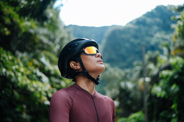 A young female cyclist is practising a breathing exercise.
