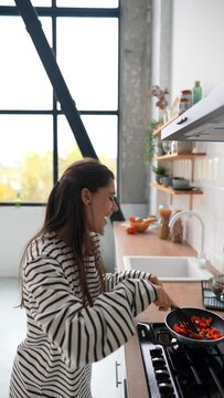 Young woman busy in modern kitchen, attractive girl preparing food