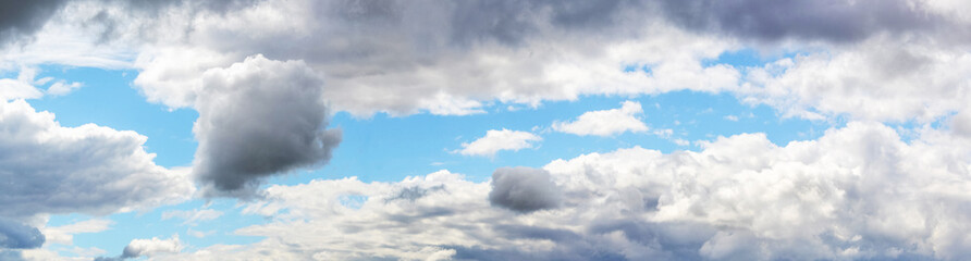 Fototapeta premium Blue sky with various white and gray clouds in sunny weather