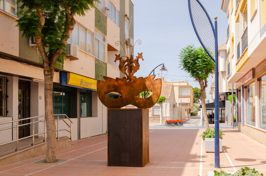 SANTIAGO DE LA RIBERA, SPAIN - JUNE 12, 2022 The sculpture depicts a carnival mask, topped by three seahorses, the distinctive Mar Menor animal chosen as the mascot of the riverside carnival