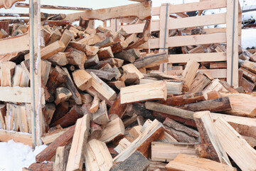 Wooden box with firewood. Chopped and hand-folded in a crate for sale or for storage in a cottage. transport by pallet truck.