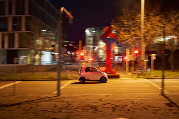 Panning of white car in the city. Smart driving fast in road traffic. Road in early morning at rush...