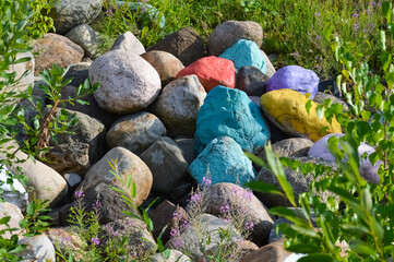 A pile of large multi-colored cobblestones lying on the ground