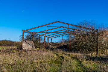 A view towards an abandoned, derelict barn near to Lubenham, UK in winter