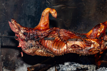 Cooking of "Su porceddu", traditional Sardinian pig meat, Italy