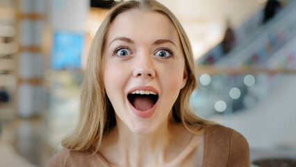 Portrait blonde happy model girl 20s woman female lady winner surprised enthusiastic looking at...
