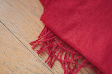 Close up of red autumn and winter scarf made from polyester with fringe