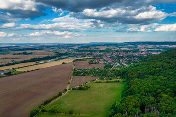 Fototapeta na wymiar Aer ial view of a German village surrounded by meadows, farmland and forest in Germany.
