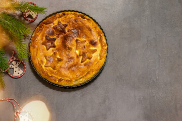 Pie with Christmas pattern - Christmas trees and stars. top view . On a grey background