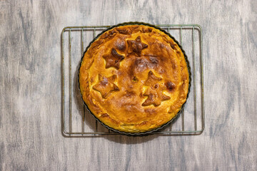 Pie with Christmas pattern - Christmas trees and stars. top view . On a grey background