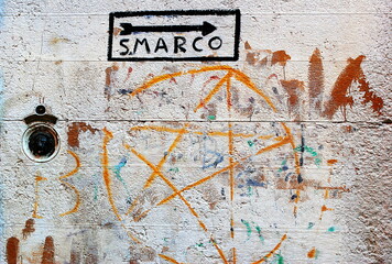 Paintings on the wall in Venice. Murales with directions for Piazza San Marco in the narrow streets of the centre. Venice, Italy - November 01th 2013 