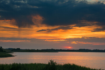 Fototapeta na wymiar Serene landscape with a lake lake in the evening