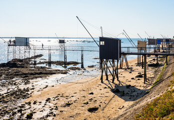 Fototapeta na wymiar Wooden fishing cabins with a large square lift net called 