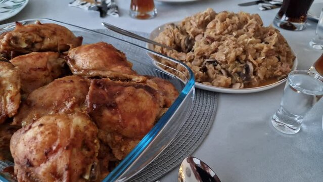 Woman hands serving roasted pieces of a chicken and traditional hunter`s stew dish during party or in the restaurant