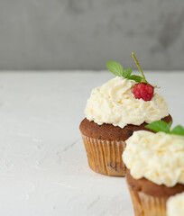 Baked cupcakes with white butter cream on the table, delicious dessert