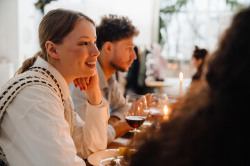 Cheerful woman having Christmas dinner with her friends