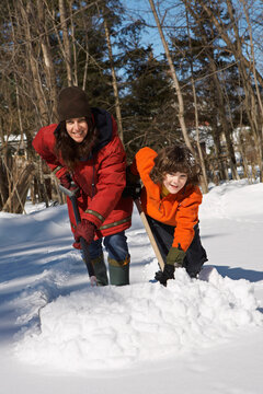 Mother and Son Shoveling Snow