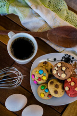 biscuit, biscuit, chocolate, with chocolate drops, traditional, cream, milk, chocolate, and with toppings, a delight with coffee made in an artisan way, set on a rustic wooden table.