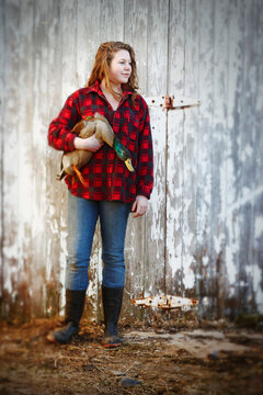 Teenage Girl holding Mallard Drake in front of Barn, Belledune, New Brunswick, Canada