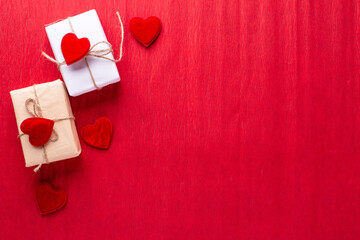 Romantic postcard. Boxes with presents with hearts on red paper texture background.  Place for text. Top view. St. Valentines day, Mothers day postcard.